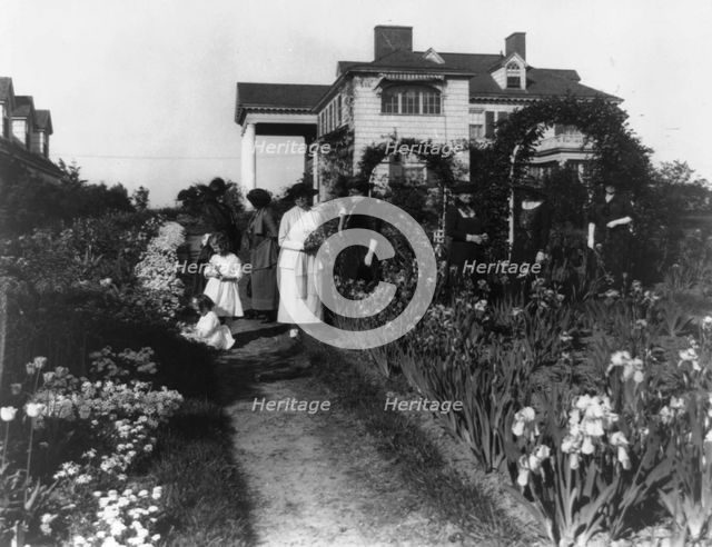 Seven women and two small girls in the garden of Mrs. John W. Paris...New York, between 1909 & 1927. Creator: Frances Benjamin Johnston.