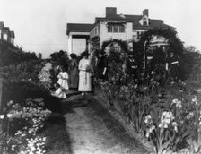 Seven women and two small girls in the garden of Mrs. John W. Paris...New York, between 1909 & 1927. Creator: Frances Benjamin Johnston