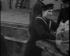 Several Male Crew, Including One from the Royal Navy, Inspecting the Cargo of a Large Vessel, 1939. Creator: British Pathe Ltd
