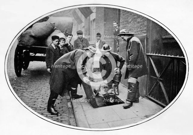 Sewermen going below, London, c1903 (1903). Artist: Unknown.