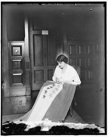Sewing stars on suffrage flag, between 1910 and 1920. Creator: Harris & Ewing