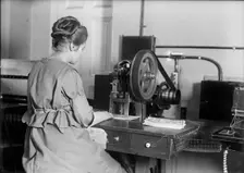 Seal of The United States - Stamping Bonds, 1917. Creator: Harris & Ewing