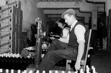 Sealing bottles of port wine at the Cutler Street warehouses, London, c1945-1965. Artist: SW Rawlings