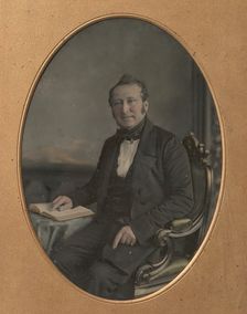 Seated Man Pointing to a Passage in an Open Book, 1850s. Creator: John Jabez Edwin Mayall