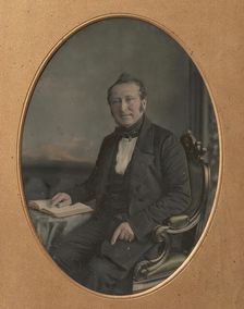 Seated Man Pointing to a Passage in an Open Book, 1850s. Creator: John Jabez Edwin Mayall