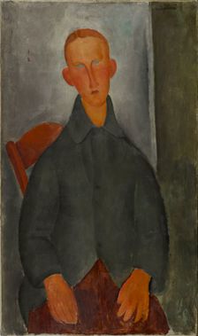Seated boy with red hair and grey jacket