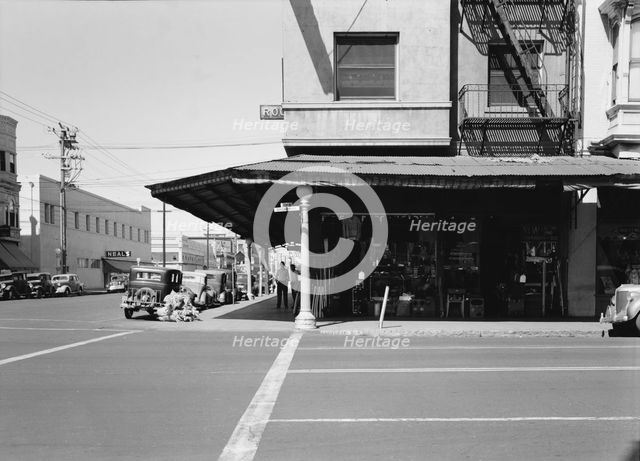 Secondhand store, street corner of San Joaquin Valley town on U.S. 99, Fresno, CA, 1939. Creator: Dorothea Lange.