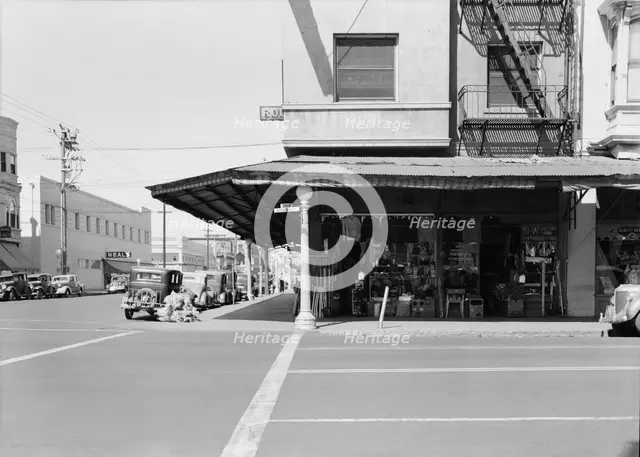 Secondhand store, street corner of San Joaquin Valley town on U.S. 99, Fresno, CA, 1939. Creator: Dorothea Lange.