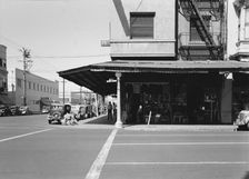 Secondhand store, street corner of San Joaquin Valley town on U.S. 99, Fresno, CA, 1939. Creator: Dorothea Lange