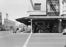 Secondhand store, street corner of San Joaquin Valley town on U.S. 99, Fresno, CA, 1939. Creator: Dorothea Lange