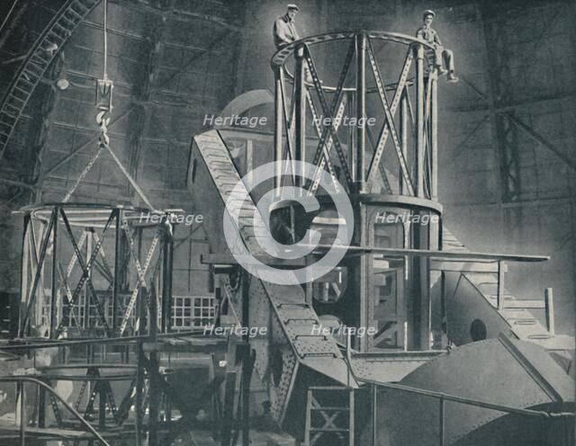 'Section By Section Mounts The Huge Steel Framework of the Hooker's Cylinder', c1935. Artist: Unknown.