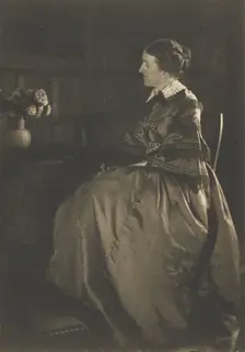 Self-portrait with Table and Flowers, 1896-1899. Creator: Gertrude Kasebier