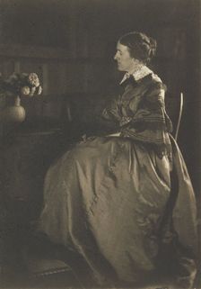 Self-portrait with Table and Flowers, 1896-1899. Creator: Gertrude Kasebier