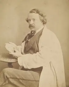 Self-portrait holding medallion commemorating his deceased mother, 1860-1861. Creator: Nadar