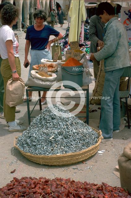 Selling spices and fish in Gabes market. Artist: Unknown