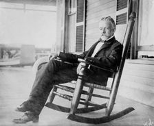 Sen. H.C. Lodge in rocker on porch, 1910. Creator: Bain News Service