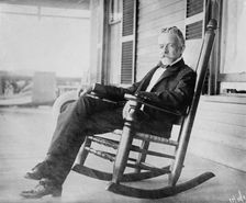 Sen. H.C. Lodge in rocker on porch, 1910. Creator: Bain News Service