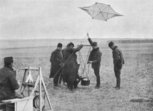 Sending up one of the French war kites, to which a camera is attached 1914, (1915)