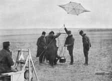 Sending up one of the French war kites, to which a camera is attached 1914, (1915)