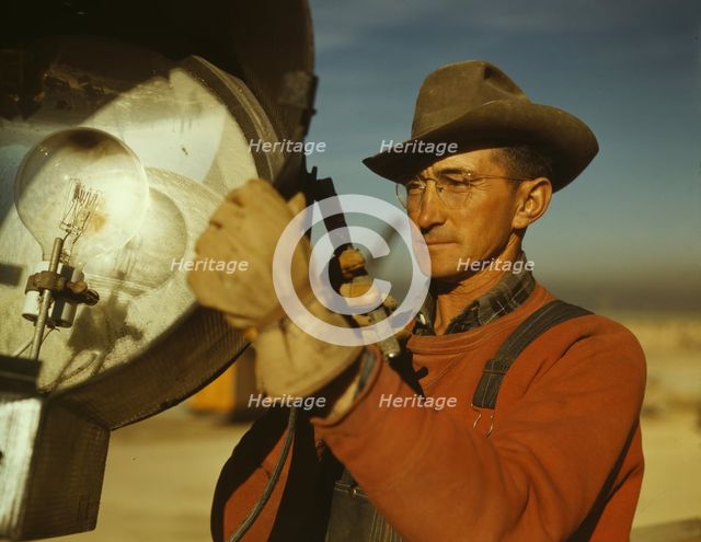 Servicing one of the floodlights that turn night into day..., Columbia Steel Co., Geneva, Utah, 1942 Creator: Andreas Feininger.