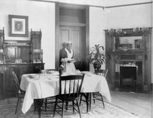 Serving the dinner, 1899 or 1900. Creator: Frances Benjamin Johnston