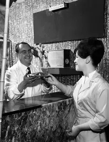 Serving a meal to a customer in a cafe, Mexborough, South Yorkshire, 1964. Creator: Michael Walters
