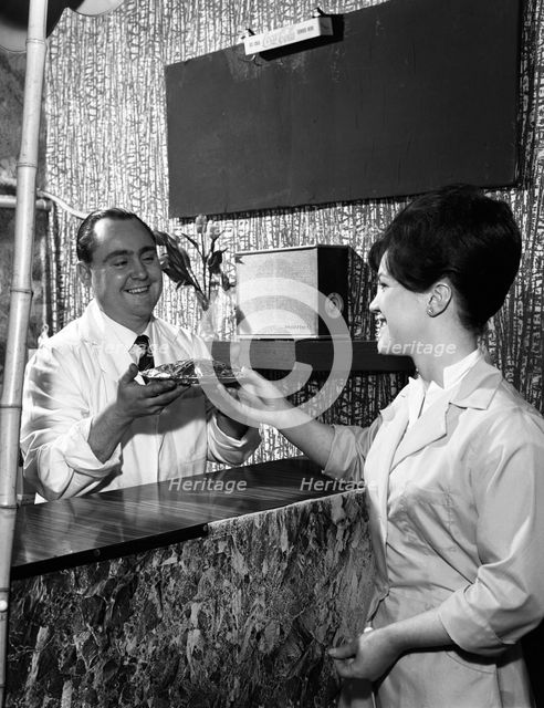 Serving a meal to a customer in a cafe, Mexborough, South Yorkshire, 1964. Artist: Michael Walters