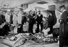 Serving out a day's fresh meat ration on board HMS Talbot 1896. Artist: WM Crockett