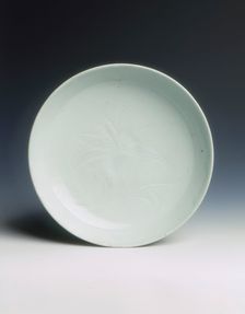 Shufu porcelain saucer with carved lotus, Yuan dynasty, China, 14th century. Creator: Unknown