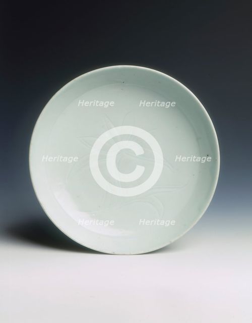 Shufu porcelain saucer with carved lotus, Yuan dynasty, China, 14th century. Creator: Unknown.