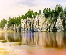 Shaitan Rock; general view from the village of Novaia Derevnia, Chusovaya River, 1912. Creator: Sergey Mikhaylovich Prokudin-Gorsky
