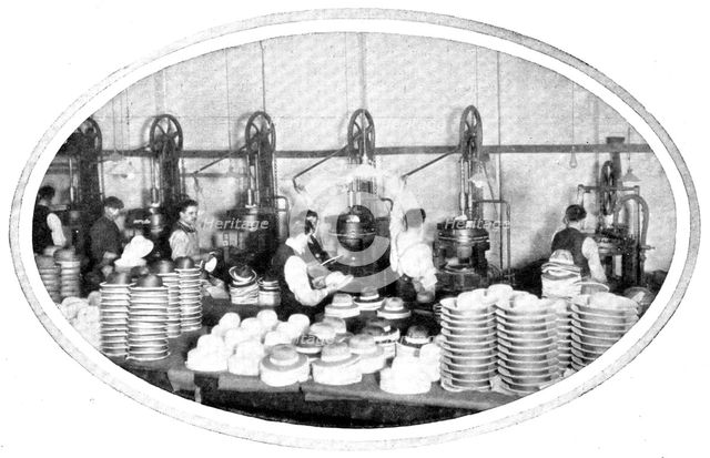 Shaping hats and helmets: the hydraulic presses at work, 1909. Creator: Unknown.