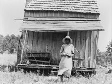 Sharecropper's cabin and sharecropper's wife, Ten miles south of Jackson, Mississippi, 1937. Creator: Dorothea Lange