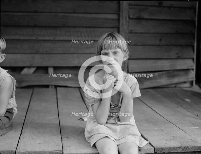 Sharecropper's child whose father receives five dollars a month, Macon County, Georgia, 1937. Creator: Dorothea Lange.