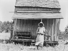 Sharecropper's cabin and sharecropper's wife, Ten miles south of Jackson, Mississippi, 1937. Creator: Dorothea Lange