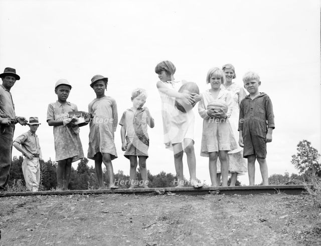 Sharecroppers' families gathering needs for their 4th of July celebration..., Mississippi, 1936. Creator: Dorothea Lange.