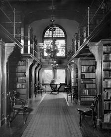 Shelves in library, U.S. Naval Academy, between 1890 and 1901. Creator: Unknown