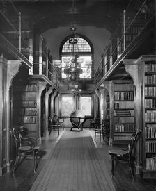 Shelves in library, U.S. Naval Academy, between 1890 and 1901. Creator: Unknown