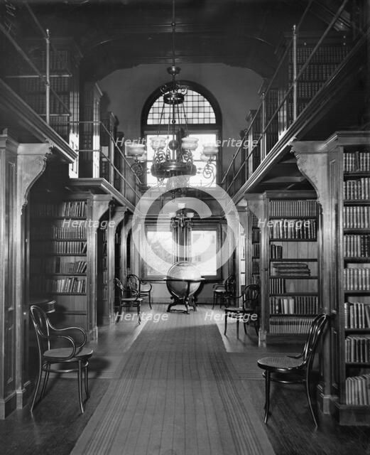 Shelves in library, U.S. Naval Academy, between 1890 and 1901. Creator: Unknown.