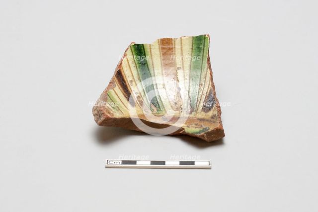 sherd, red body, white slip; green, brown, yellow striped glaze, Mamluk period, 1250-1516. Creator: Unknown.