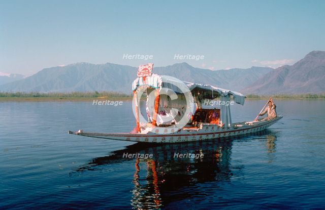Shikara (traditional wooden boat) on Dal Lake, Srinagar, Kashmir, India.