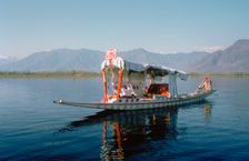Shikara (traditional wooden boat) on Dal Lake, Srinagar, Kashmir, India