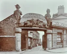 Ships figureheads over the gate at Castle's Shipbreaking Yard, Westminster, London, 1909