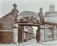 Ships figureheads over the gate at Castle's Shipbreaking Yard, Westminster, London, 1909