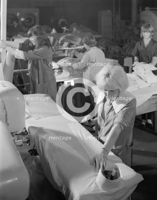Shirt pressing at a commercial laundry in Scunthorpe, Lincolnshire, 1965.  Creator: Michael Walters.
