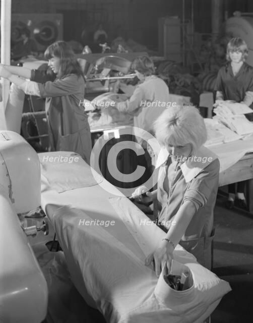 Shirt pressing at a commercial laundry in Scunthorpe, Lincolnshire, 1965.  Artist: Michael Walters