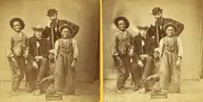 Shoe Blacks. [Studio portrait of three young shoe shiners and their customers], (1868-1900?). Creator: Unknown