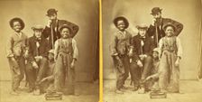 Shoe Blacks. [Studio portrait of three young shoe shiners and their customers], (1868-1900?). Creator: Unknown