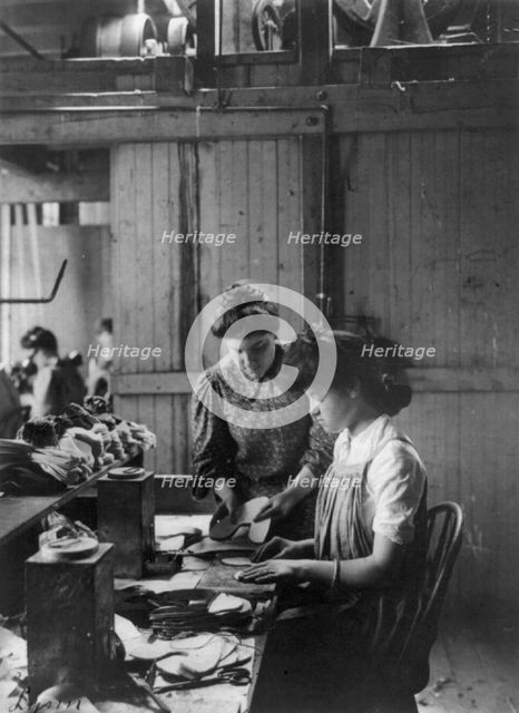 Shoe factories, Lynn, Mass.: 2 women working in shoe factory, (1895?). Creator: Frances Benjamin Johnston.