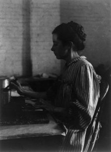 Shoe factories, Lynn, Mass.: woman seated at table, working in shoe factory, (1895?). Creator: Frances Benjamin Johnston